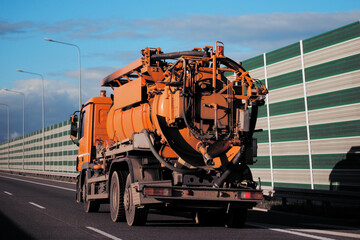 Sewage Truck In Motion On a European Highway. Waste Distribution And Utilization Policy Concept. Process of waste recycling. Sewage treatment.