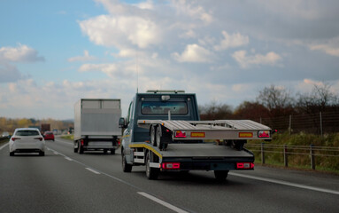 Fototapeta na wymiar A Towing Vehicle With A Medium Size Trailer On Board