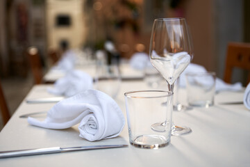 A restaurant on the street of an old town. Serving tables waiting for visitors. Copy space.