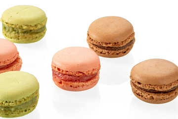 Tasty multi-colored macaroons on a white background close-up