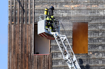 fireman with self-contained breathing apparatus with the oxygen cylinder in the destroyed building...