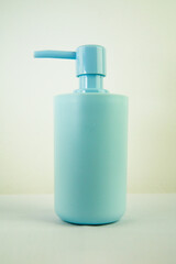 bottle of shampoo, plastic liquid soap dish, light blue