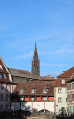Single Bell Tower of the Historic Strasbourg Cathedral in France and houses in Petite  France Quartier