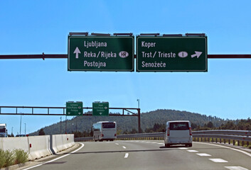 road signs on the Slovenian highway to reach Ljubljana or go towards the Italian borders and the city of Trieste - obrazy, fototapety, plakaty