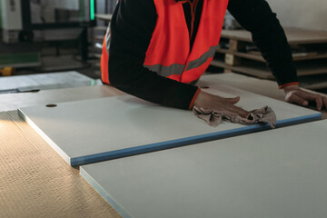 Fototapeta premium A worker prepares PVC furniture boards for packaging
