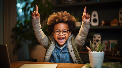 Child celebrating victory over solving a difficult homework assignment, raising his hands up and laughing