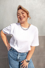 A beautiful plus size woman dressed  jeans, white t-shirt and  fashion  accessories. Latin american...