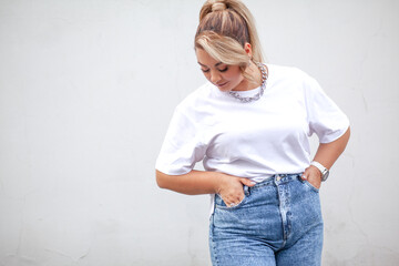A beautiful plus size woman dressed  jeans, white t-shirt and  fashion  accessories. Latin american...