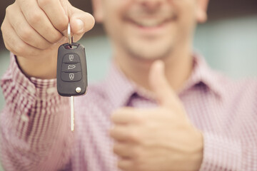Close up of smile man, holding car keys.