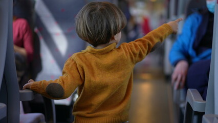 Child pointing finger inside train transportation, little boy childhood education concept of not...