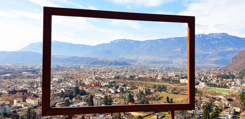 View of the city of Bolzano through an iron frame. Panorama. - obrazy, fototapety, plakaty
