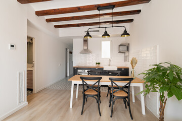 Dining table in equipped kitchen area of studio apartment
