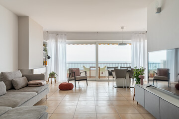 Light spacious living room with large balcony at seaside