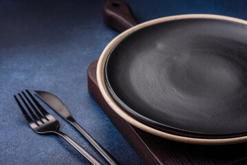 Round empty colored ceramic plate on concrete texture background