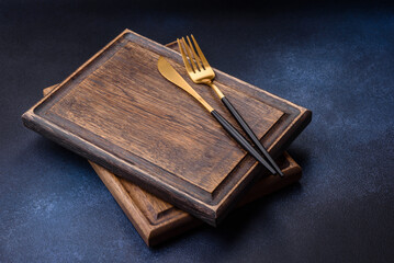 Empty rectangular wooden cutting board on dark concrete background