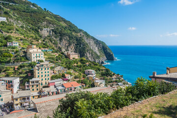 Fototapeta na wymiar Hill with houses set in the mountain next to the Mediterranean Sea, Riomaggiore ITALY