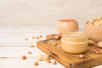 Jar of peanut butter on wooden table