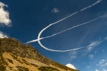 Contrails, Condensation Trails, or Vapour Trails looking like a trident. - 679859827