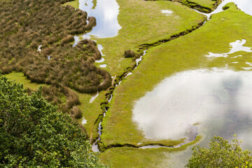 Banks of river in North Wales with tidal edge and pond from above. - 679860427