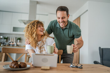 happy couple man and woman husband and wife morning routine use tablet