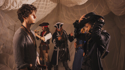 A merry band of pirates, a group photo in carnival costumes, corsairs on the background of sails