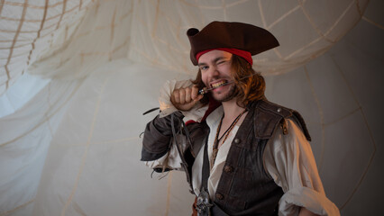 A reckless pirate in a cocked hat, a guy in a pirate costume, a sea robber, a portrait on a...