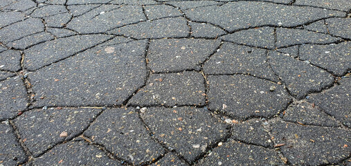 Cracks in the asphalt on the highway. Old road with cracked, damaged, destroyed, worn, broken,...
