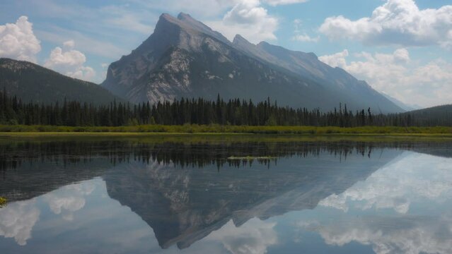 Mount Rundle reflecting in the Vermillion Lake near Banff, Canada. Timelapse. 