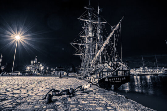 old wooden sail ships moored in the harbor of La Rochelle near the gabut district. night shot