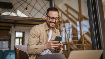 One adult man work at home use smart phone app or send sms