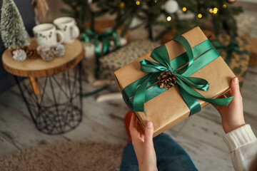 Gift box in the hands of a girl, Christmas mood