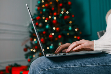 Girl working with a laptop in a Christmas atmosphere