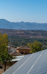 Solar panels and wind energy mills in the Granada town of Nigüelas (Spain)