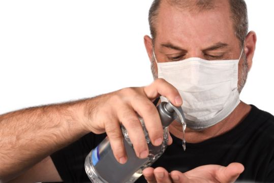 Portrait of a man, in a medical mask using alcohol gel. A concept of the danger of COVID-19 coronavirus for the elderly. on white background with space for text