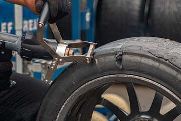 Fototapeta na wymiar a racing tire beeing cleaned/scraped