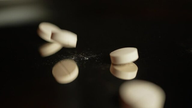 Medications pills and drugs spilled out at the table. Pharmaceutical Industry. Modern drug and pharmacy, addiction, slow motion. National Opioid Awareness Day and legalization of heavy narcotics.