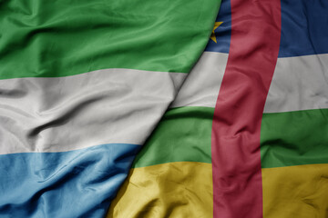 Fototapeta premium big waving national colorful flag of sierra leone and national flag of central african republic .