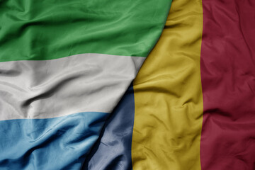 Fototapeta premium big waving national colorful flag of sierra leone and national flag of chad .