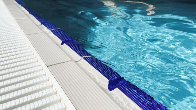The calm splash of water against the side of the overflow pool slowmo