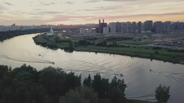 A green district of city with parks, river and high-rise residential buildings.