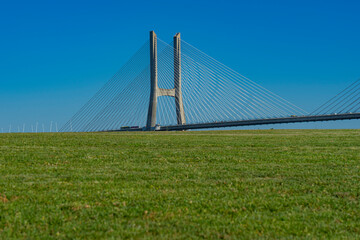 Pillars of Vasco da Gama bridge hidden by lawn. Image captured on July 14, two weeks before the start of the world youth days event