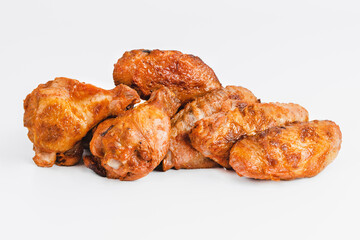 Chicken wings fried until half cooked, semi-finished product with fresh herbs on a white background. Fast food. Fast cooking.Quick cooking at home. Copy space.Fast homemade food.Raw chicken meat.