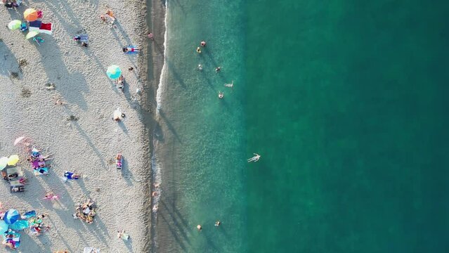 Beach with vacationers, view from a copter.