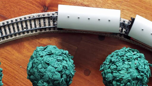 Electric Model Train on Model Railway Tracks. Elevated View. Close Up. 4K Resolution.