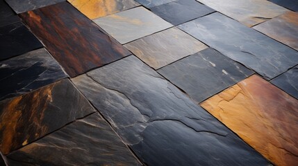 A close-up photograph of polished slate floor tiles with their distinctive texture and earthy tones, creating a cozy and rustic ambiance in a space.