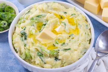 Traditional Irish dish Colcannon or mashed potato with green cabbage and butter, horizontal closeup