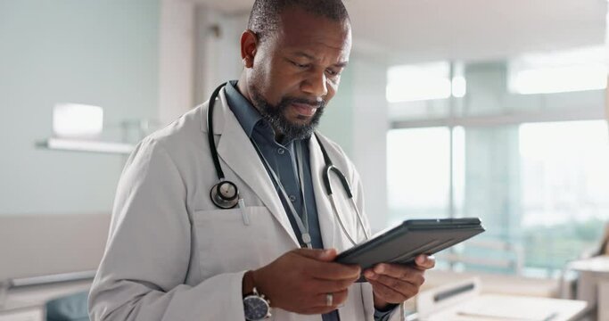 Healthcare, typing and a black man or doctor with a tablet for a medical app or communication. Mature, reading email and an African surgeon with technology for results, information or surgery advice