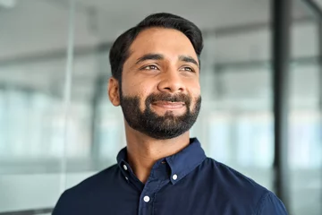 Foto op Aluminium Confident smiling Indian business man, bearded professional businessman manager in office, corporate executive leader, male entrepreneur from India looking away, headshot close up face portrait. © insta_photos