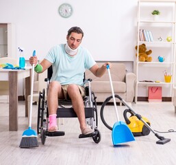 Young man in wheel-chair cleaning the house