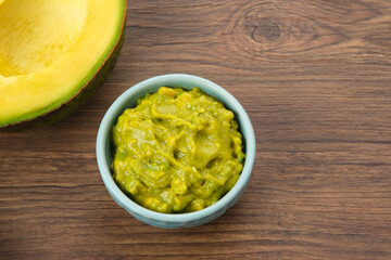 Delicious Avocado Puree and fresh fruit on wooden background
